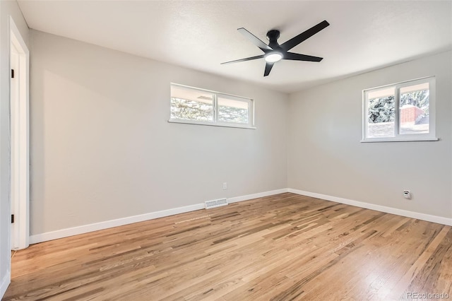 empty room with light wood-type flooring, baseboards, visible vents, and ceiling fan