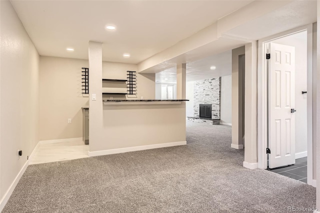 kitchen with dark countertops, recessed lighting, baseboards, and carpet floors