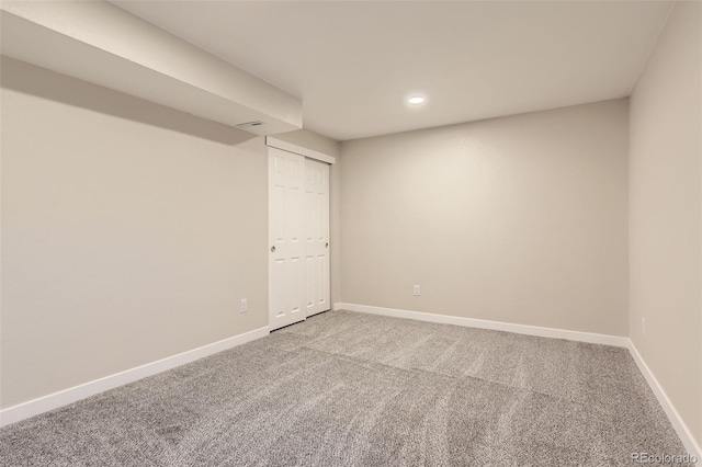 empty room featuring recessed lighting, baseboards, and carpet