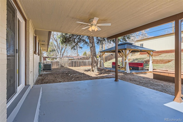 view of patio / terrace featuring a gazebo, a fenced backyard, cooling unit, and ceiling fan