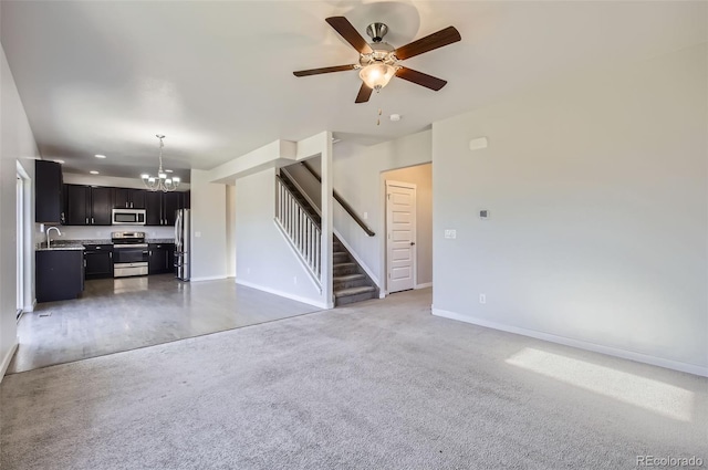 1464 Moraine Valley Dr, Severance, CO 80550 - unfurnished living room with a chandelier, stairs, ceiling fan, and carpet floors