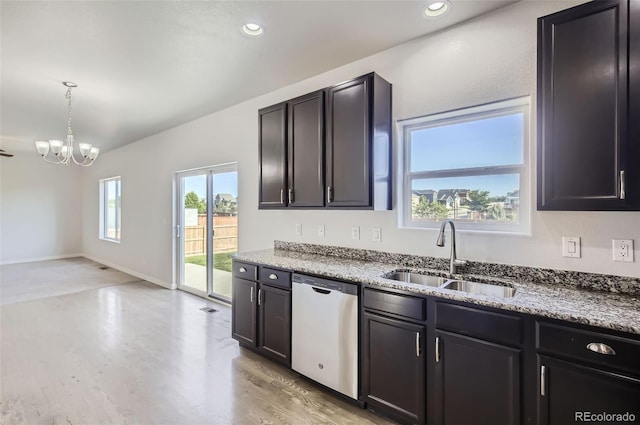 1464 Moraine Valley Dr, Severance, CO 80550 - kitchen featuring stainless steel dishwasher, light wood finished floors, light stone counters, a chandelier, and recessed lighting
