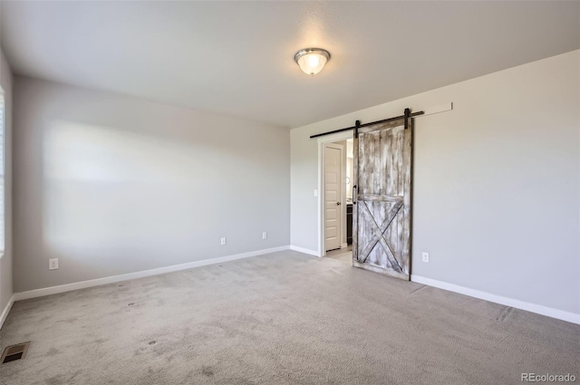 1464 Moraine Valley Dr, Severance, CO 80550 - spare room featuring a barn door and carpet