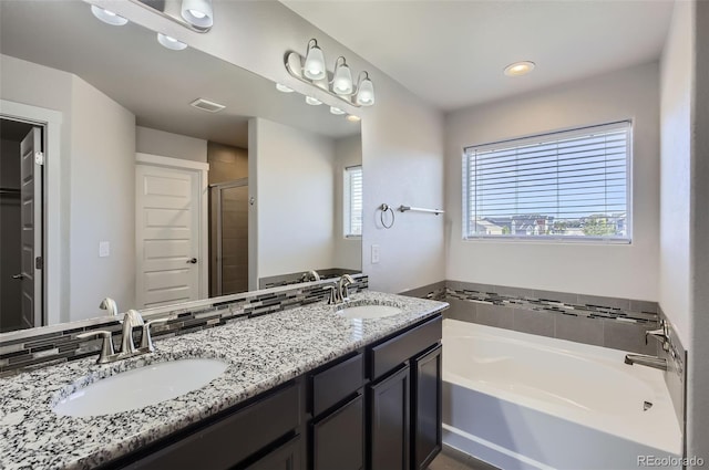 1464 Moraine Valley Dr, Severance, CO 80550 - bathroom with a garden tub, a shower stall, double vanity, and recessed lighting