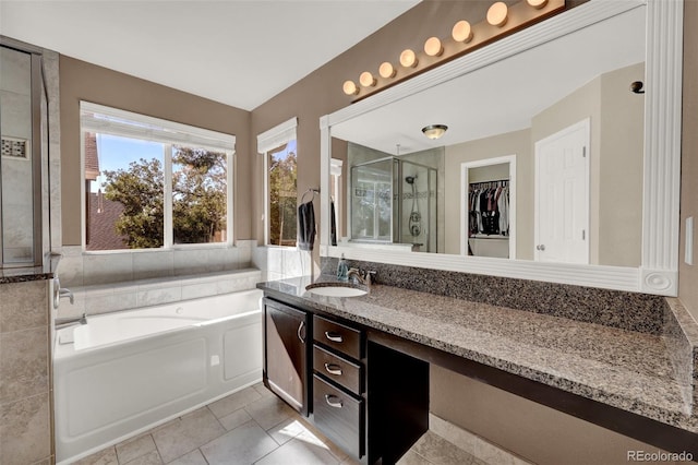 5415 Spruce Ave, Castle Rock, CO 80104 - full bath featuring a bath, a shower stall, vanity, a walk in closet, and tile patterned floors