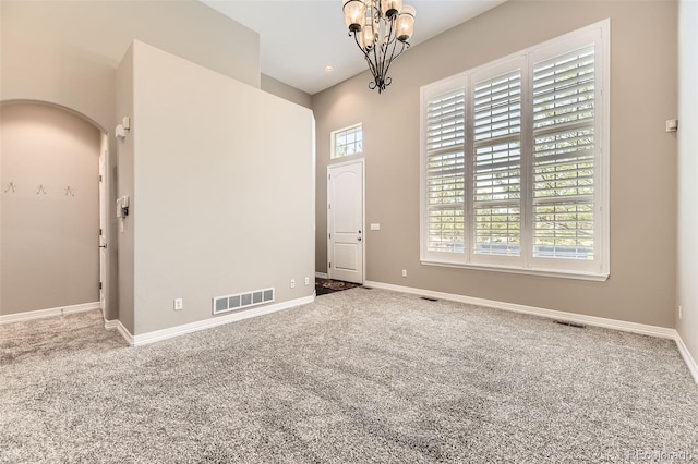 10311 Belvedere Ln, Lone Tree, CO 80124 - spare room with carpet, a chandelier, baseboards, and arched walkways