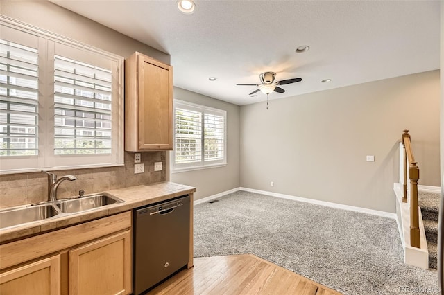 10311 Belvedere Ln, Lone Tree, CO 80124 - kitchen with stainless steel dishwasher, light brown cabinets, a ceiling fan, a sink, and baseboards