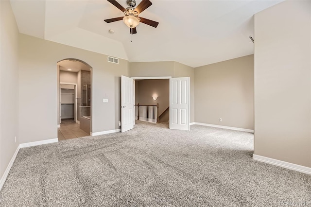 10311 Belvedere Ln, Lone Tree, CO 80124 - unfurnished bedroom with arched walkways, light carpet, baseboards, vaulted ceiling, and ceiling fan