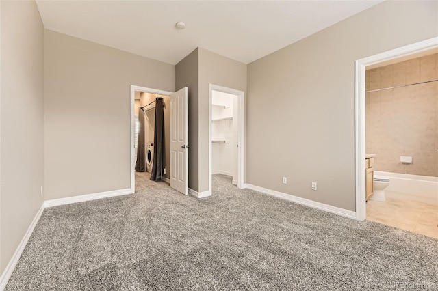 10311 Belvedere Ln, Lone Tree, CO 80124 - unfurnished bedroom with carpet flooring, a walk in closet, and ensuite bathroom