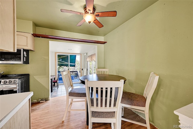 dining room with light wood-type flooring and ceiling fan