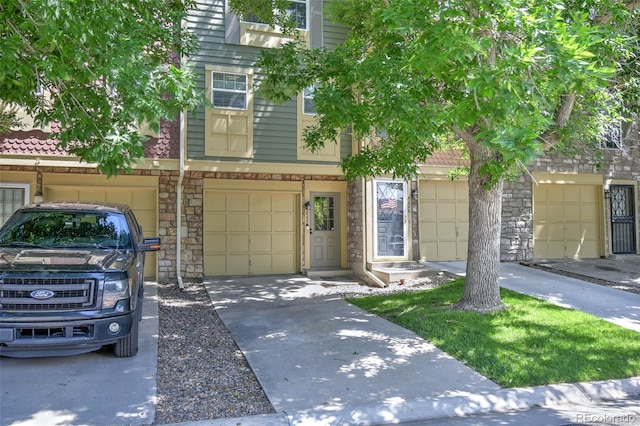 8022 S Columbine Ct, Centennial, CO 80122 - multi unit property featuring stone siding, driveway, and a garage