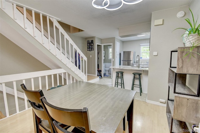8022 S Columbine Ct, Centennial, CO 80122 - dining room with light wood-type flooring and stairs