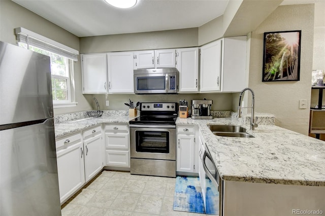 8022 S Columbine Ct, Centennial, CO 80122 - kitchen with stainless steel appliances, a peninsula, light stone countertops, and white cabinets
