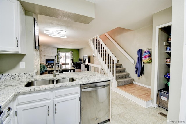8022 S Columbine Ct, Centennial, CO 80122 - kitchen with dishwasher, white cabinetry, light stone counters, and a peninsula