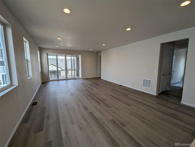 unfurnished living room with dark hardwood / wood-style floors