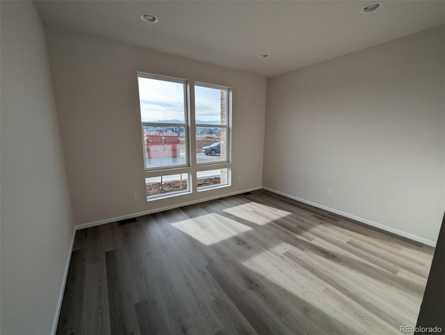 empty room with light hardwood / wood-style flooring