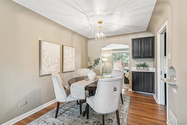 1060 S Harrison St, Denver, CO 80209 - dining space with arched walkways, wood finished floors, and a chandelier
