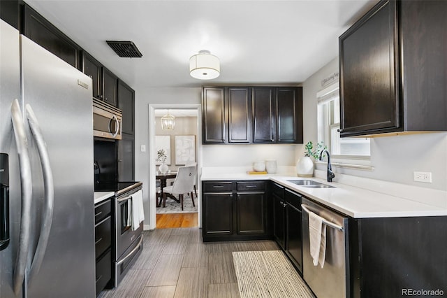 1060 S Harrison St, Denver, CO 80209 - kitchen featuring stainless steel appliances, light countertops, and wood finished floors