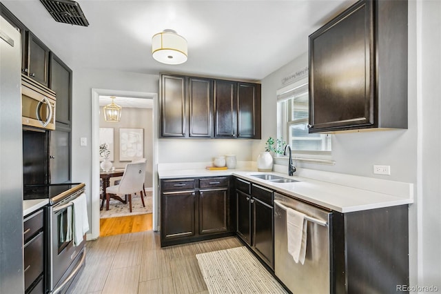 1060 S Harrison St, Denver, CO 80209 - kitchen with stainless steel appliances, dark brown cabinetry, and light countertops