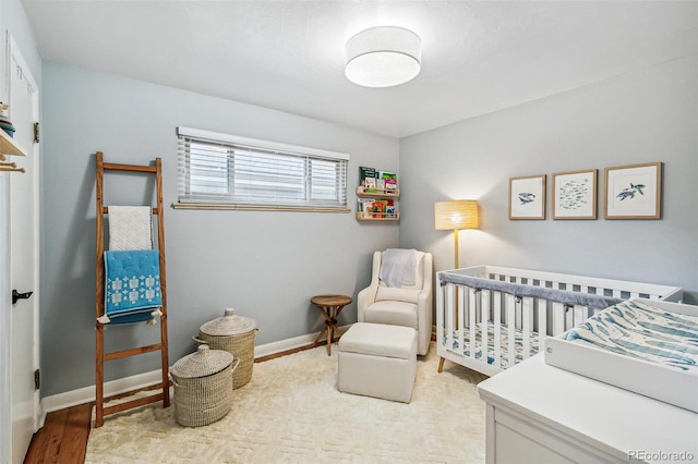 1060 S Harrison St, Denver, CO 80209 - bedroom with a crib and wood finished floors