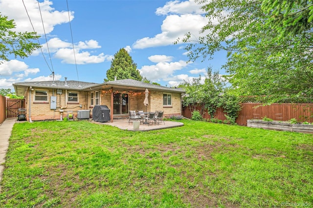 1060 S Harrison St, Denver, CO 80209 - back of property with a fenced backyard, a patio, and brick siding