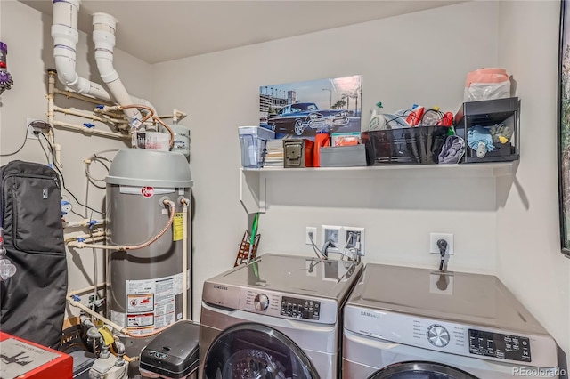 laundry area with washing machine and clothes dryer and water heater