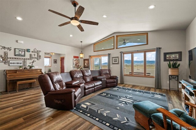 living room featuring dark hardwood / wood-style floors, vaulted ceiling, and ceiling fan