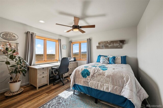 bedroom with ceiling fan and dark wood-type flooring