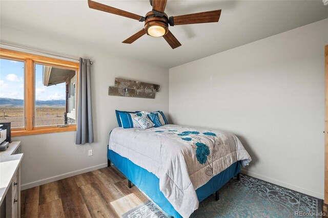 bedroom featuring ceiling fan and wood-type flooring