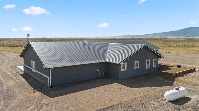 back of property with a mountain view