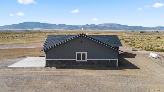 view of property exterior with a mountain view