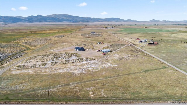 drone / aerial view featuring a mountain view and a rural view