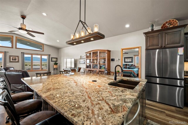 kitchen featuring billiards, a center island with sink, sink, stainless steel appliances, and lofted ceiling