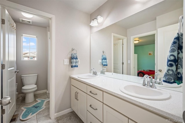 15194 W Washburn Ave, Lakewood, CO 80228 - bathroom featuring ensuite bath, double vanity, and tile patterned floors