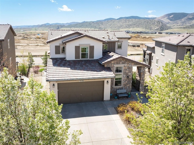 15194 W Washburn Ave, Lakewood, CO 80228 - view of front of house with a tiled roof, stucco siding, driveway, and a mountain view