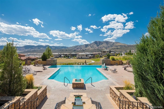 15194 W Washburn Ave, Lakewood, CO 80228 - community pool featuring a mountain view and a patio