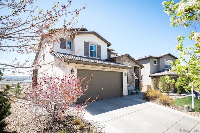 15194 W Washburn Ave, Lakewood, CO 80228 - view of front of house featuring stucco siding, driveway, and a tiled roof