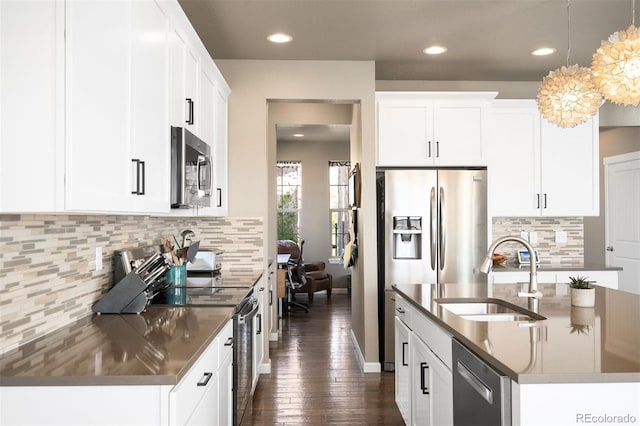 15194 W Washburn Ave, Lakewood, CO 80228 - kitchen featuring stainless steel appliances, decorative backsplash, dark wood-type flooring, decorative light fixtures, and recessed lighting