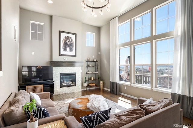 15194 W Washburn Ave, Lakewood, CO 80228 - living area with a chandelier, wood finished floors, and a tile fireplace