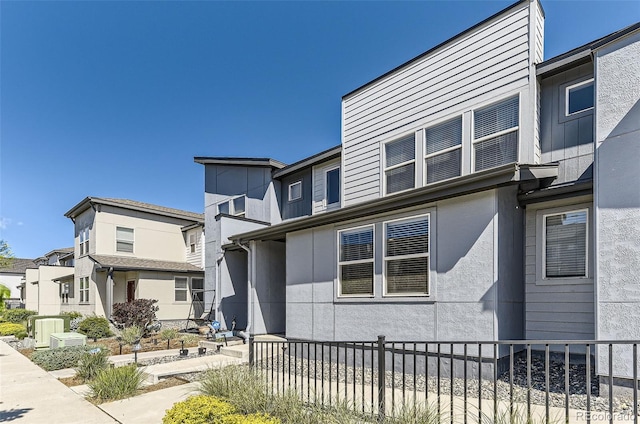 16057 E 47th Pl, Denver, CO 80239 - view of front of home featuring fence, stucco siding, and a residential view