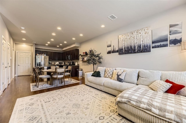 16057 E 47th Pl, Denver, CO 80239 - living room featuring dark wood-style floors and recessed lighting
