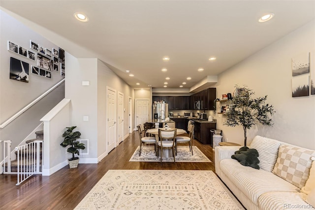 16057 E 47th Pl, Denver, CO 80239 - living room featuring dark wood-type flooring, stairs, recessed lighting, and baseboards
