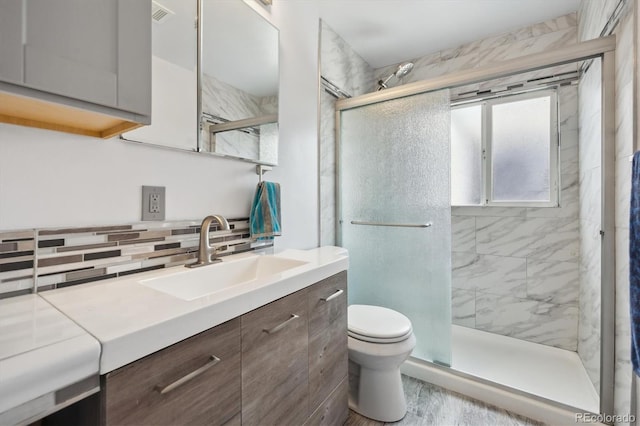 1995 Xenia St, Denver, CO 80220 - full bath featuring backsplash, toilet, a stall shower, and vanity