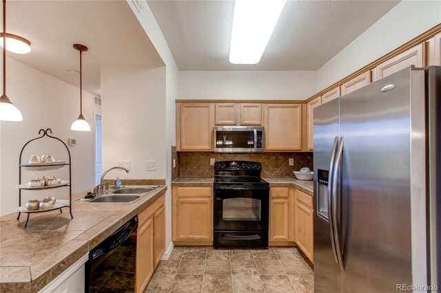 804 Summer Hawk Dr Unit 3202, Longmont, CO 80504 - kitchen with black appliances, a peninsula, light brown cabinets, and decorative backsplash