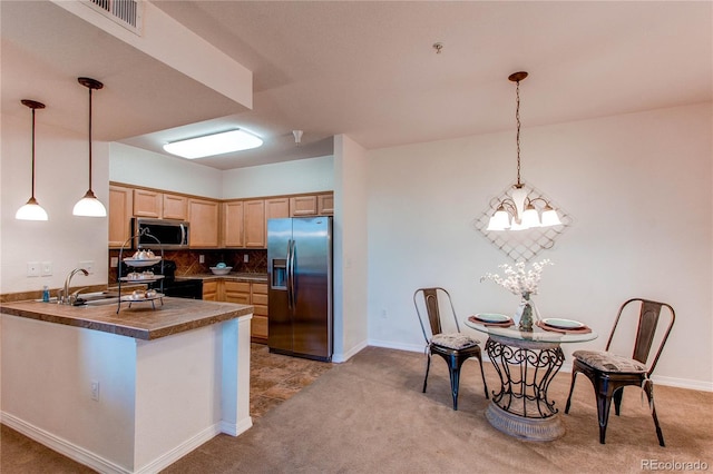 804 Summer Hawk Dr Unit 3202, Longmont, CO 80504 - kitchen with stainless steel appliances, light brown cabinetry, dark countertops, light carpet, and a peninsula