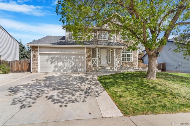 524 Rider Ridge Dr, Longmont, CO 80504 - traditional-style house featuring stone siding, concrete driveway, fence, and a front lawn