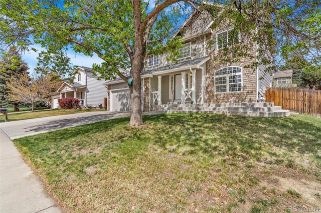 524 Rider Ridge Dr, Longmont, CO 80504 - traditional-style home featuring covered porch, stone siding, an attached garage, fence, and concrete driveway