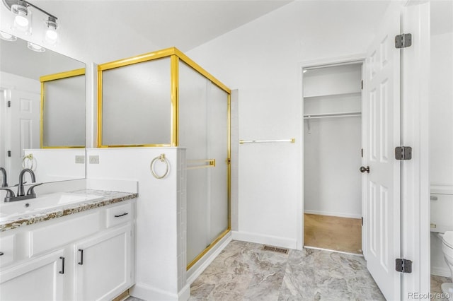 524 Rider Ridge Dr, Longmont, CO 80504 - bathroom with toilet, vanity, visible vents, a stall shower, and baseboards