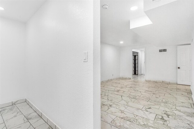 524 Rider Ridge Dr, Longmont, CO 80504 - spare room featuring visible vents, marble finish floor, baseboards, and recessed lighting