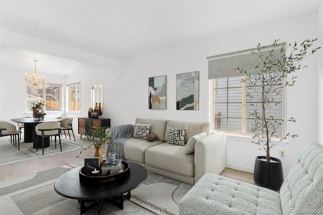 524 Rider Ridge Dr, Longmont, CO 80504 - living room featuring baseboards, an inviting chandelier, and wood finished floors